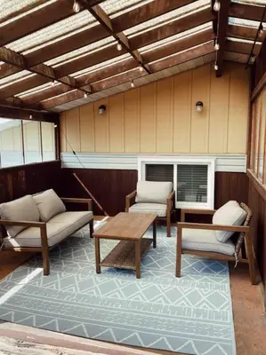 a screened porch with chairs and a table and a window at Elegant Boho Retreat - 8 min to WEM in Edmonton