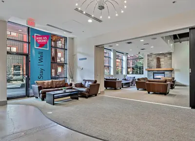 a lobby with couches and chairs in a building at Marvellous Mountain Condo- Pets - Pool & Hot Tub managed by Little Sister Getaways in Canmore