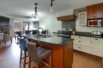 a kitchen with a kitchen island with a counter top at Marvellous Mountain Condo- Pets - Pool & Hot Tub managed by Little Sister Getaways in Canmore