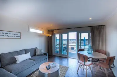 a living room with a couch and a table at Qualicum Beach Ocean Suites in Qualicum Beach