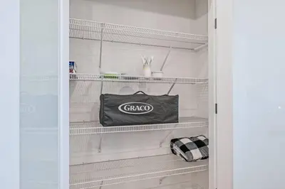 a closet with a choco bag on a shelf at LovelyHome-Foosball-NearAirport-5 Queen Beds -Air conditioning in Edmonton