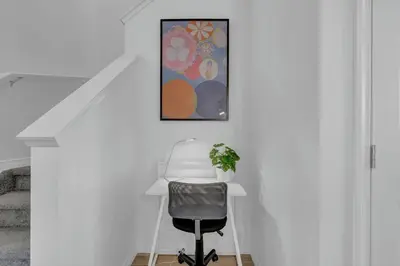 a white office with a desk and a chair at LovelyHome-Foosball-NearAirport-5 Queen Beds -Air conditioning in Edmonton