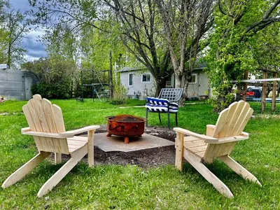 two chairs and a fire pit in a yard at Farmstay in Edmonton in Duffield