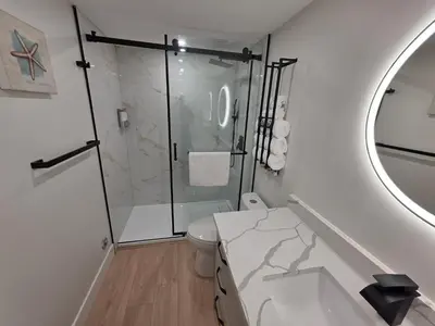 a bathroom with a shower and a toilet and a sink at Premium Deluxe PeachView Suites 3BR in Peachland