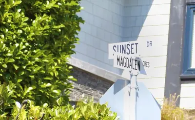 a street sign on top of a stop sign at White Rock Beach getaway in White Rock