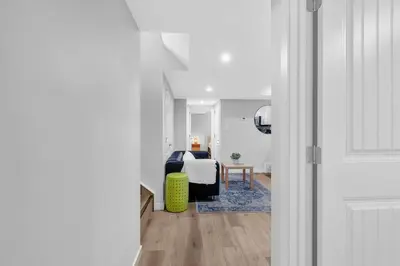 a bedroom with a bed in a white room at ModernSuite*NearAirport*2Queens*2Bedroom*FullKitchen in Edmonton