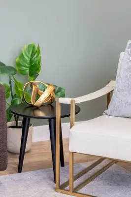 a chair and a table with a basket on top of it at Pet Friendly & Accessible, 4 Beds in Calgary