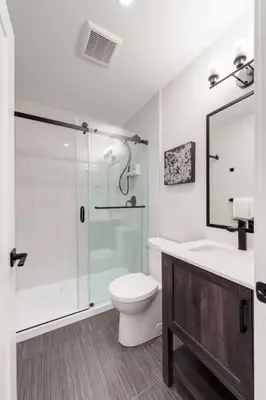 a bathroom with a shower and a toilet and a sink at Pet Friendly & Accessible, 4 Beds in Calgary