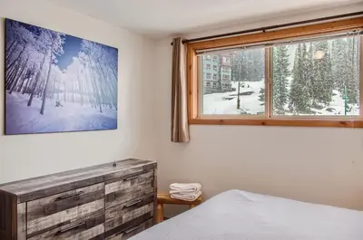 a bedroom with a bed and a window at Snowy Creek by Okanagan Premier in Big White