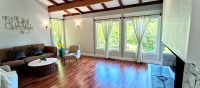 a living room with a couch and a table at White House Tofino Downtown Villa in Tofino