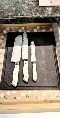 two knives sitting on top of a cutting board at White House Tofino Downtown Villa in Tofino