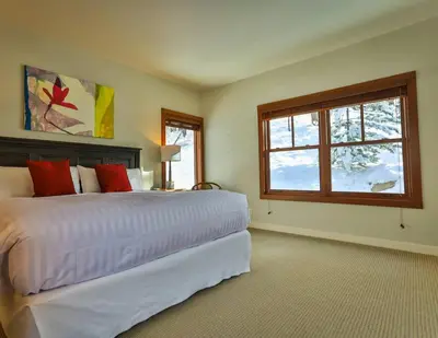 a bedroom with a large bed and a window at 4 Mt Brewer by StayIn in Panorama