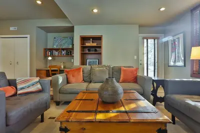 a living room with a vase on a wooden table at 4 Mt Brewer by StayIn in Panorama