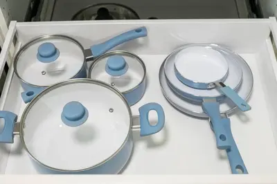 a box filled with blue and white pots and pans at Modern & Unique Studio Unit in Edmonton