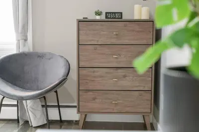 a dresser with a chair next to a drawer at Modern & Unique Studio Unit in Edmonton
