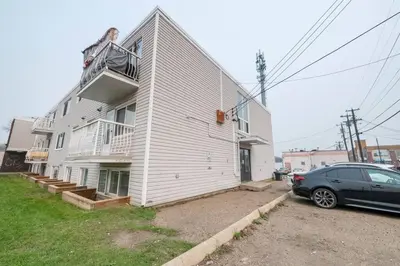 a house with a car parked in front of it at Modern & Unique Studio Unit in Edmonton