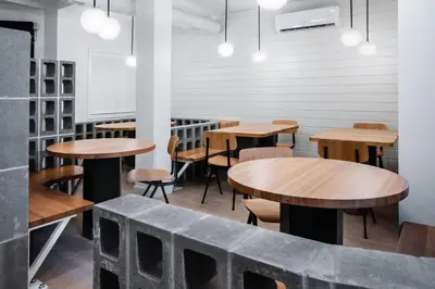 a row of tables and chairs in a restaurant at Gravity Haus Revelstoke in Revelstoke