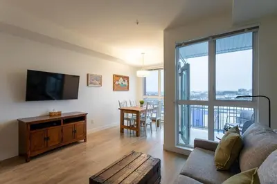 a living room with a couch and a flat screen tv at Be The Perfect Cityzen In Cityzen in Victoria