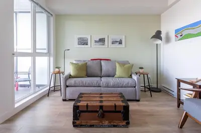a living room with a couch and a table at Be The Perfect Cityzen In Cityzen in Victoria