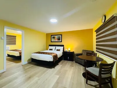 a hotel room with a bed and a table and a chair at Avola Mountain Lodge in Avola