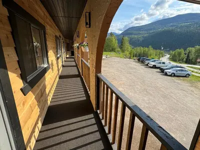 a balcony of a building with a parking lot at Avola Mountain Lodge in Avola
