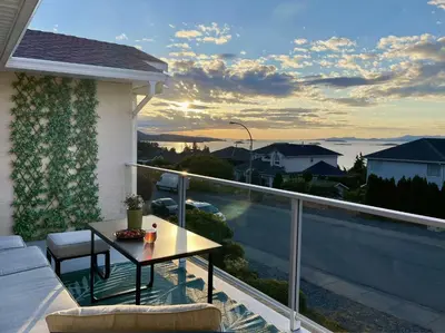 a balcony with a table and a view at Ocean View Home Nanaimo in Nanaimo