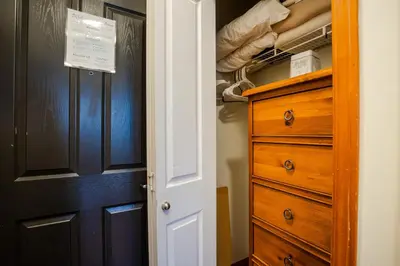 a closet with a wooden dresser and a drawer at Studio in Alpenglow Lodge, Private Balcony with Mountain Views, Gym, Epic Location in Whistler