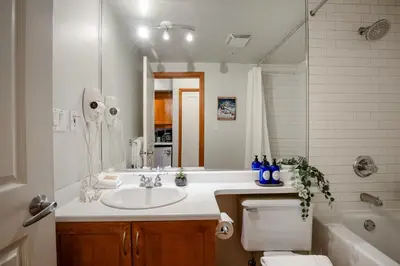 a bathroom with a sink and a tub and a toilet at Studio in Alpenglow Lodge, Private Balcony with Mountain Views, Gym, Epic Location in Whistler
