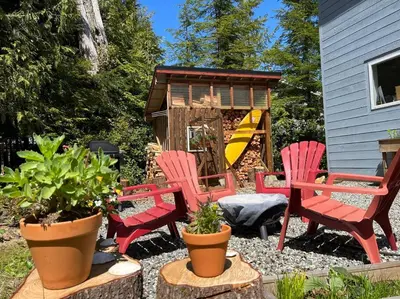 a group of red chairs and a play house at Blue Cedar Suite in Tofino