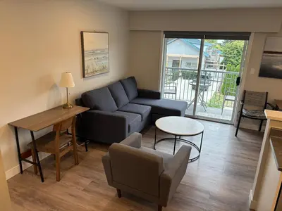 a living room with a couch and a table at Gibsons Landing Inn in Gibsons