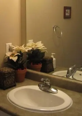 a bathroom counter with a sink and a mirror at Marine Drive Station Entire House in Vancouver