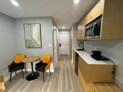 a small kitchen with a table and chairs in a room at InnTowne Motel II in Hope