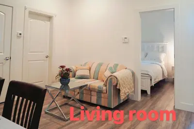 a living room with a couch and a table and a bed at Fort Langley Homestead in Maple Ridge District Municipality