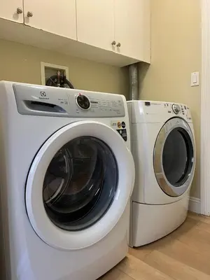 a white washing machine and a washer in a kitchen at 3 Bedrooms 1 Bath in SHARE HOUSE at Coquitlam Central Mall & skytrain in Port Coquitlam