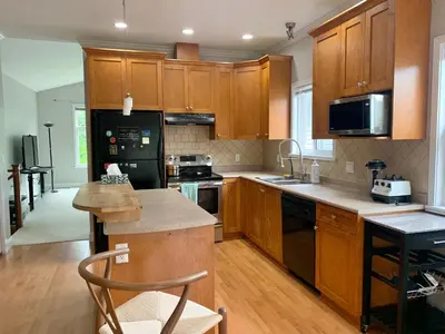 a kitchen with wooden cabinets and a counter top at 3 Bedrooms 1 Bath in SHARE HOUSE at Coquitlam Central Mall & skytrain in Port Coquitlam