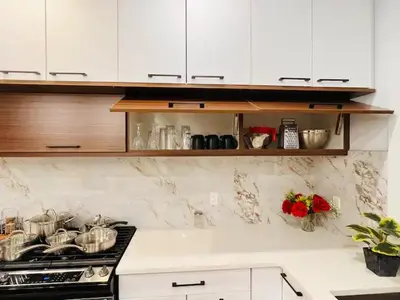 a kitchen counter with a stove and white cabinets at M21 Luxurious, Downtown River Valley Home, Centrally located, Close to everything in Edmonton
