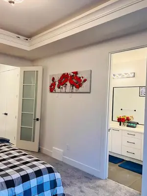 a bedroom with a bed and a dresser and a mirror at M21 Luxurious, Downtown River Valley Home, Centrally located, Close to everything in Edmonton