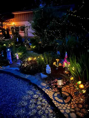 a garden lit up at night with christmas lights at The White Rabbit Inn in Courtenay