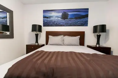 a bedroom with a large bed with two night stands at Super wow view! in Victoria