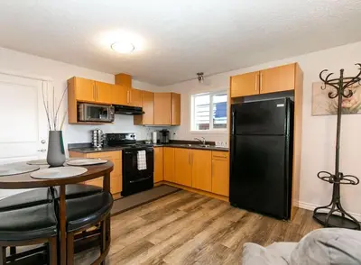 a kitchen with a black refrigerator and a table at Super wow view! in Victoria