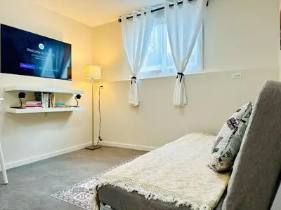 a living room with a couch and a window at 2BR 1BA Garden View Guest Suite - King-size Bed - Free Parking in Vancouver