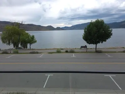 an empty parking lot next to a large body of water at PeachView Deluxe Suites 301 in Peachland
