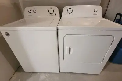 two washing machines and a washer and dryer in a room at Brand New Suite in the Lakes in Calgary
