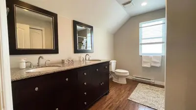 a bathroom with a sink and a toilet and a mirror at King and Queen rooms -J&J Chilliwack in Chilliwack