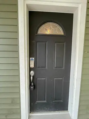a black door with a window on a house at King and Queen rooms -J&J Chilliwack in Chilliwack