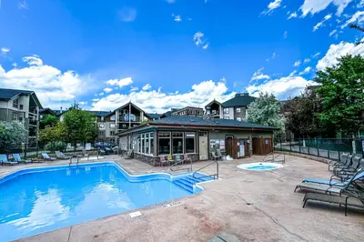 a large swimming pool in front of a building at Lake Windermere Pointe by StayIn in Invermere