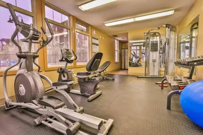 a gym with several exercise bikes and tread machines at Lake Windermere Pointe by StayIn in Invermere