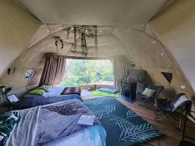 a room with two beds in a tent at D3 Rainforest Getaway Dome- 2Dbl beds in Drumheller