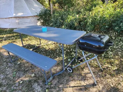 a blue picnic table with a grill and a bag on it at D5 Nordic Nook - 1 King Suite in Drumheller
