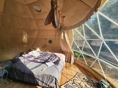 a room with a bed in a tent at D5 Nordic Nook - 1 King Suite in Drumheller